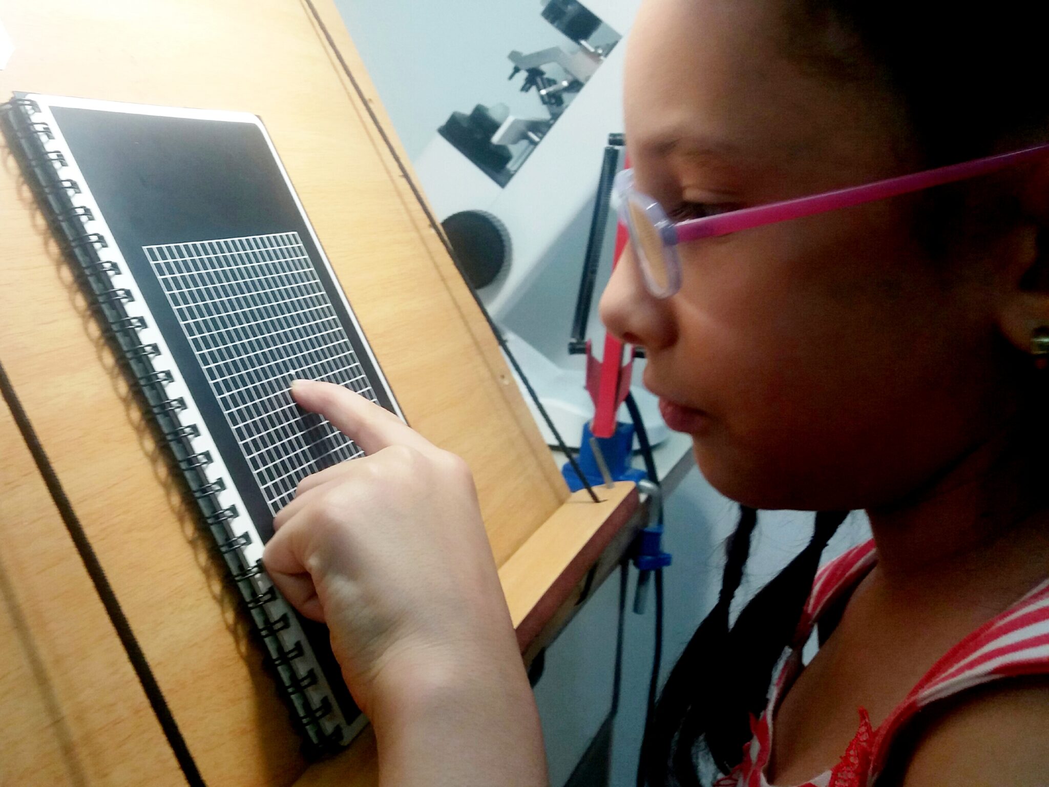 Niño leyendo con una ayuda óptica electrónica